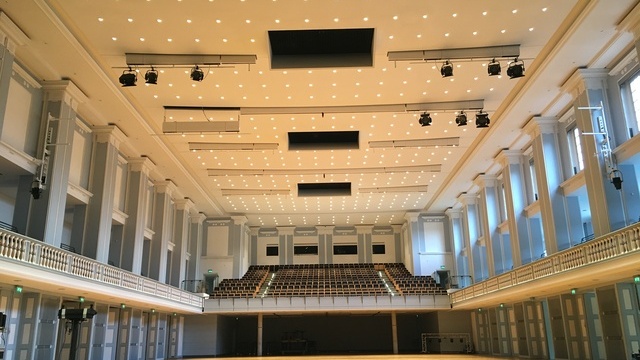Historischer Veranstaltungssaal der Stadthalle Kassel. Leerer Raum mit zweiter Ebene mit bestuhlter Empore und umlaufendem Balkon. Über die gesamte Deckenlänge sind runde Downlights der BE-Serie verteilt.  | © Hell + Dunkel | SATTLER