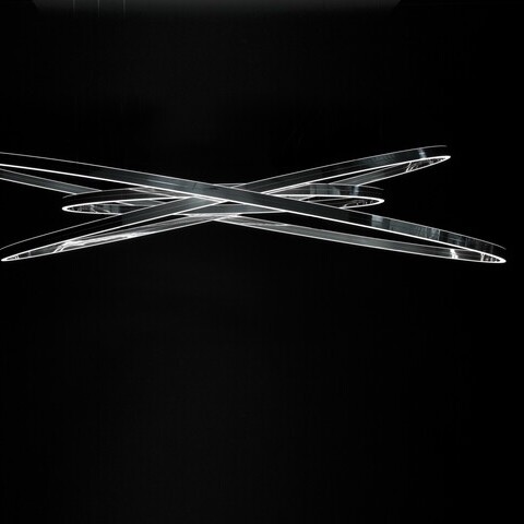 Elliptical ring lights Doppio Ellipse in three sizes suspended from each other with a polished aluminium finish.