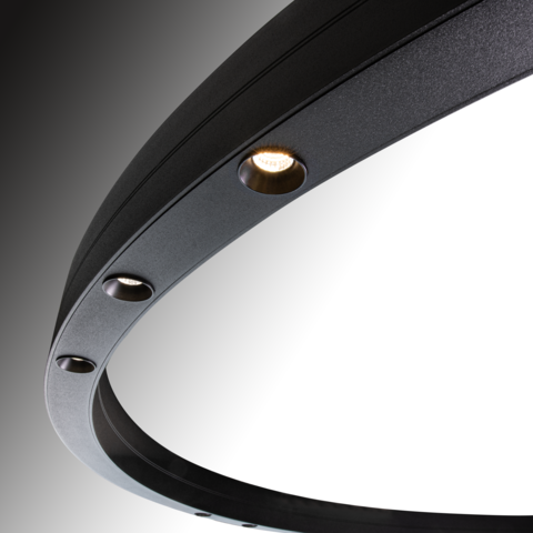 Detail of a black ring light, DUETTO LENS, three round luminous lenses are visible, directly illuminated in the centre of the ring profile.