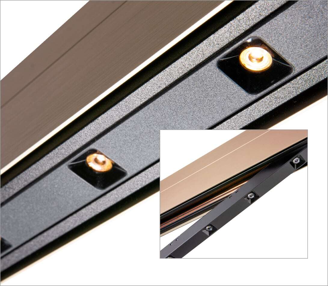 Close-up of PALADIO TRACK track light in bronze with a light insert with small lenses, with another small picture of it placed on top, with the light insert still clicked out.
