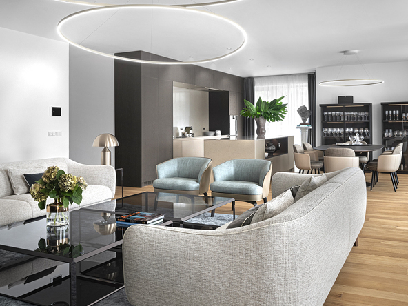 A modern sofa arrangement in shades of light grey and turquoise, with two slim ring lights suspended at different heights above the coffee table; in the background, a round wooden dining table with another SLIM ring light suspended from a round ceiling canopy. | © GERGŐ GOSZTOM