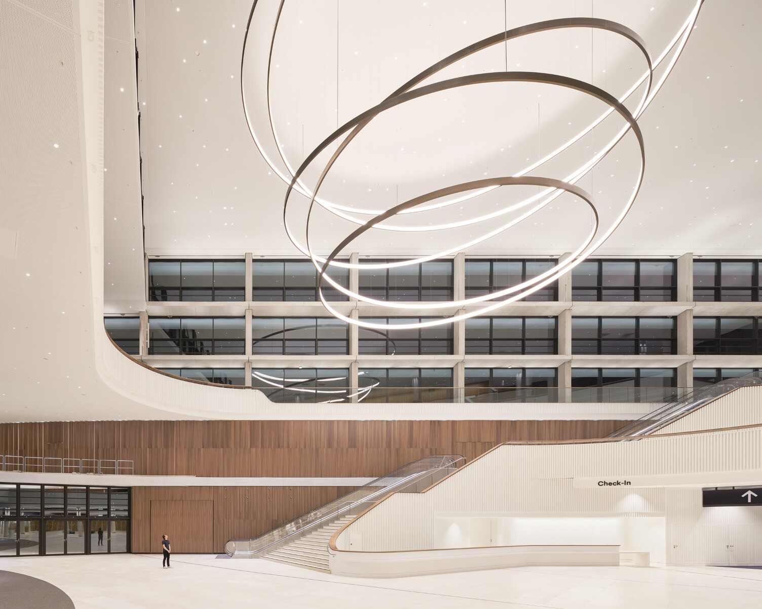 Atrium of the Congress Center Hamburg with large LED ring lights by Sattler - side perspective