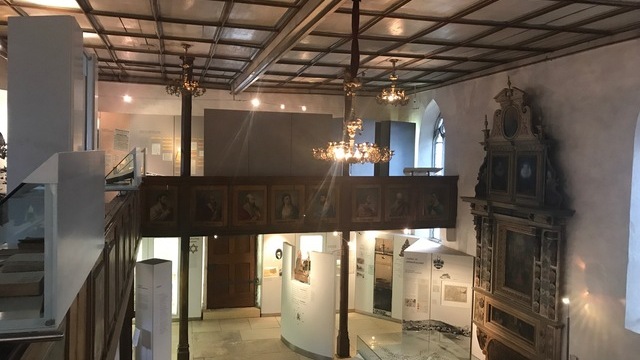 Small spotlights providing insufficient light for exhibits and information panels in the old church, which serves as a museum.