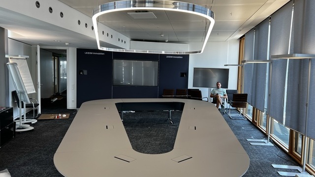 U-shaped conference table in the LBBW Stuttgart with custom-made DUETTO ring light in polished aluminium, which echoes the shape of the table.