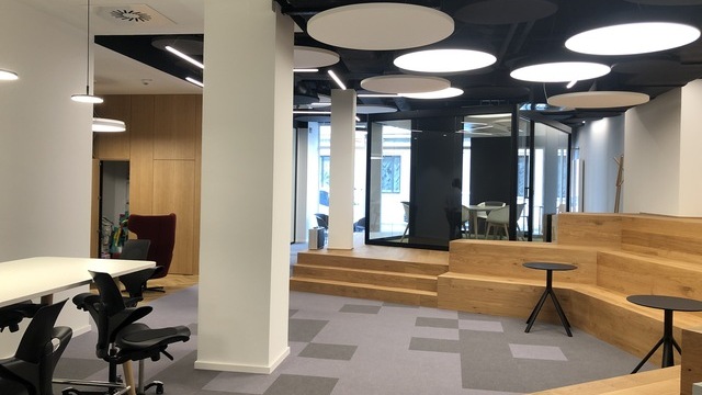 Acoustic panels with integrated lighting (Acoustic Light Panel) in a modern office and meeting area by SATTLER