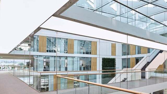 Illuminated walkways in the modern stairwell of the Sartorius office building, the underside of each staircase illuminates the corridor below. | © Studio DL
